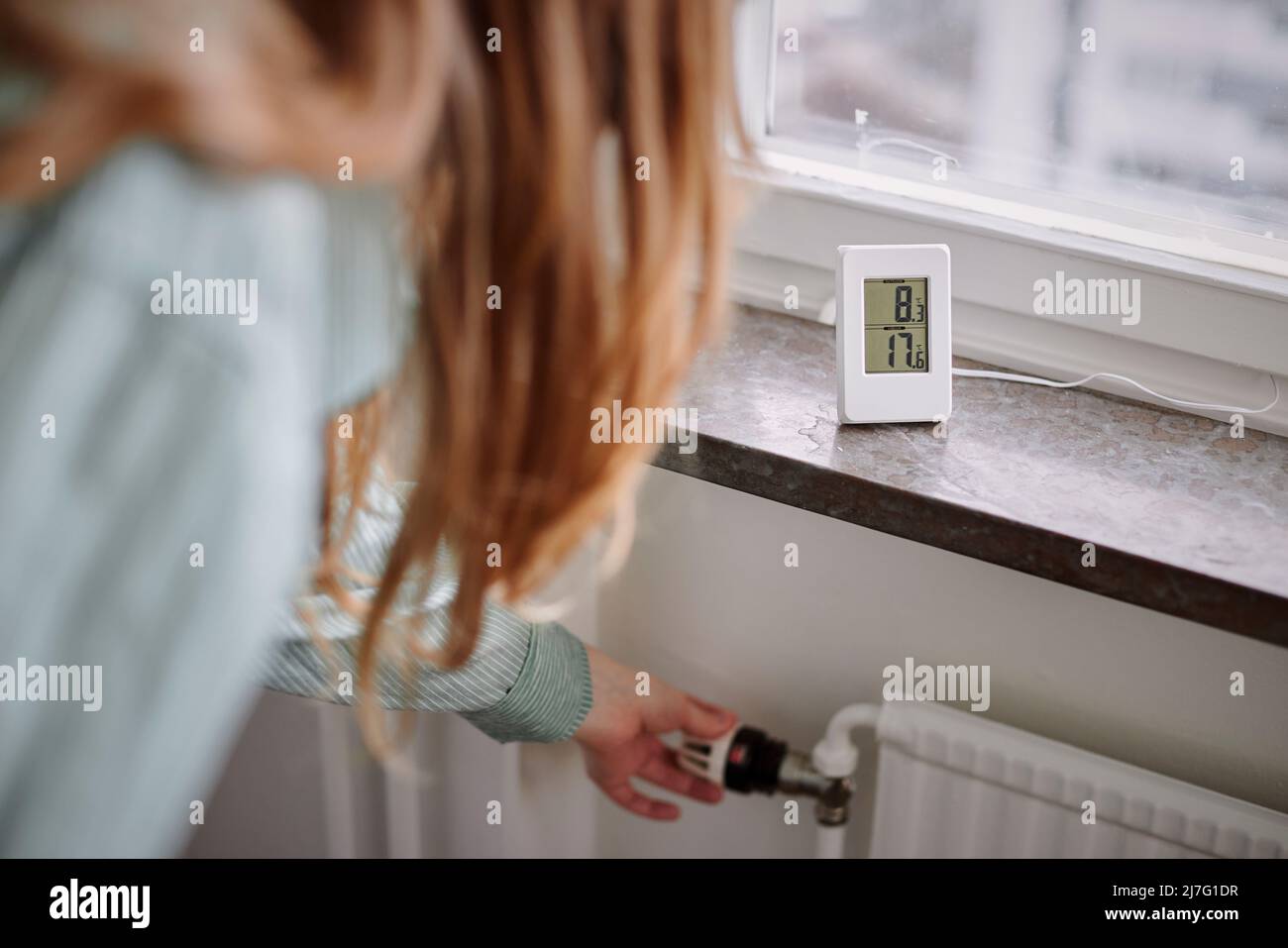 Hand adjusting temperature control in radiator Stock Photo Alamy