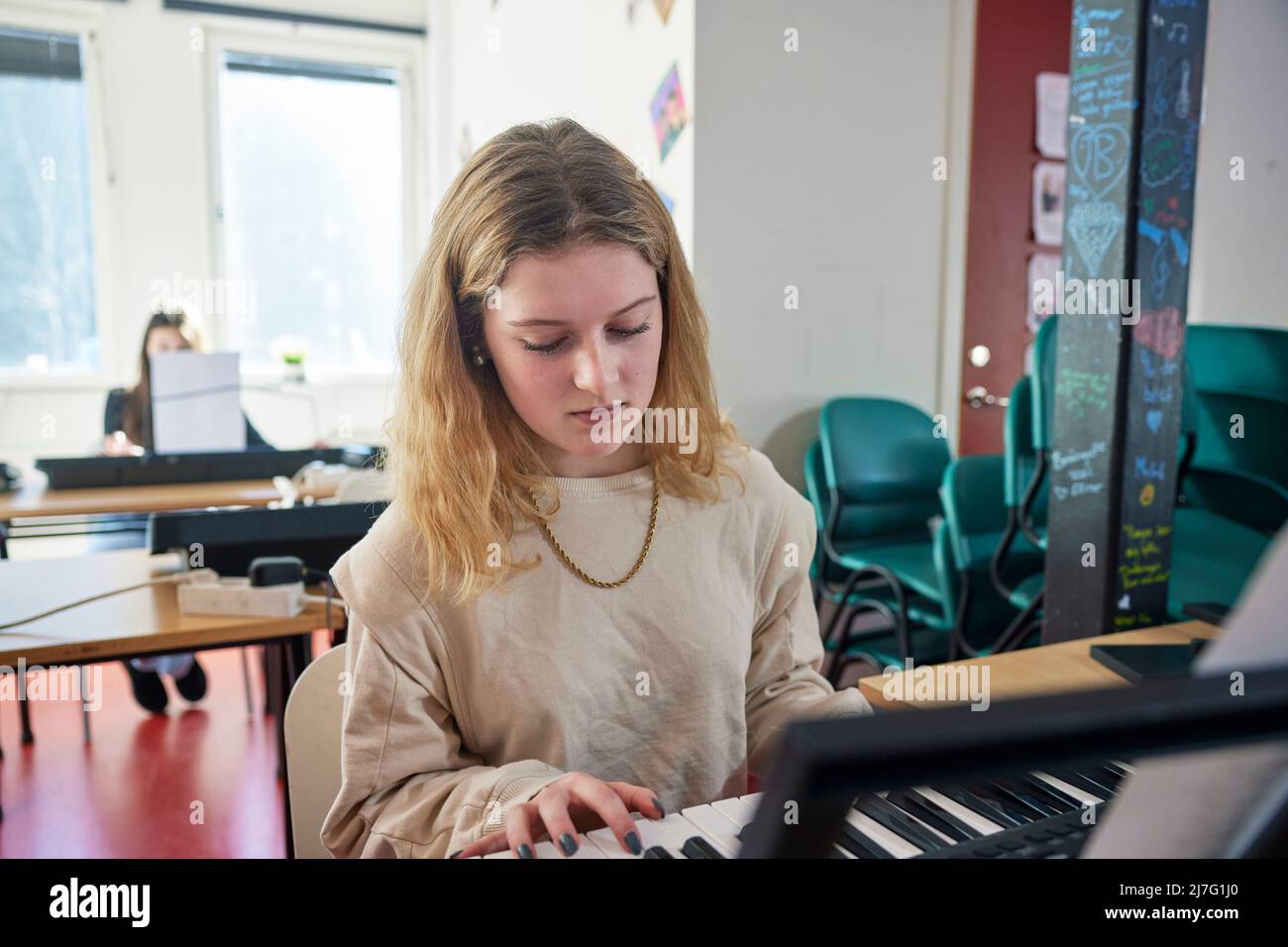 Teenage girl during keyboard lesson Stock Photo - Alamy