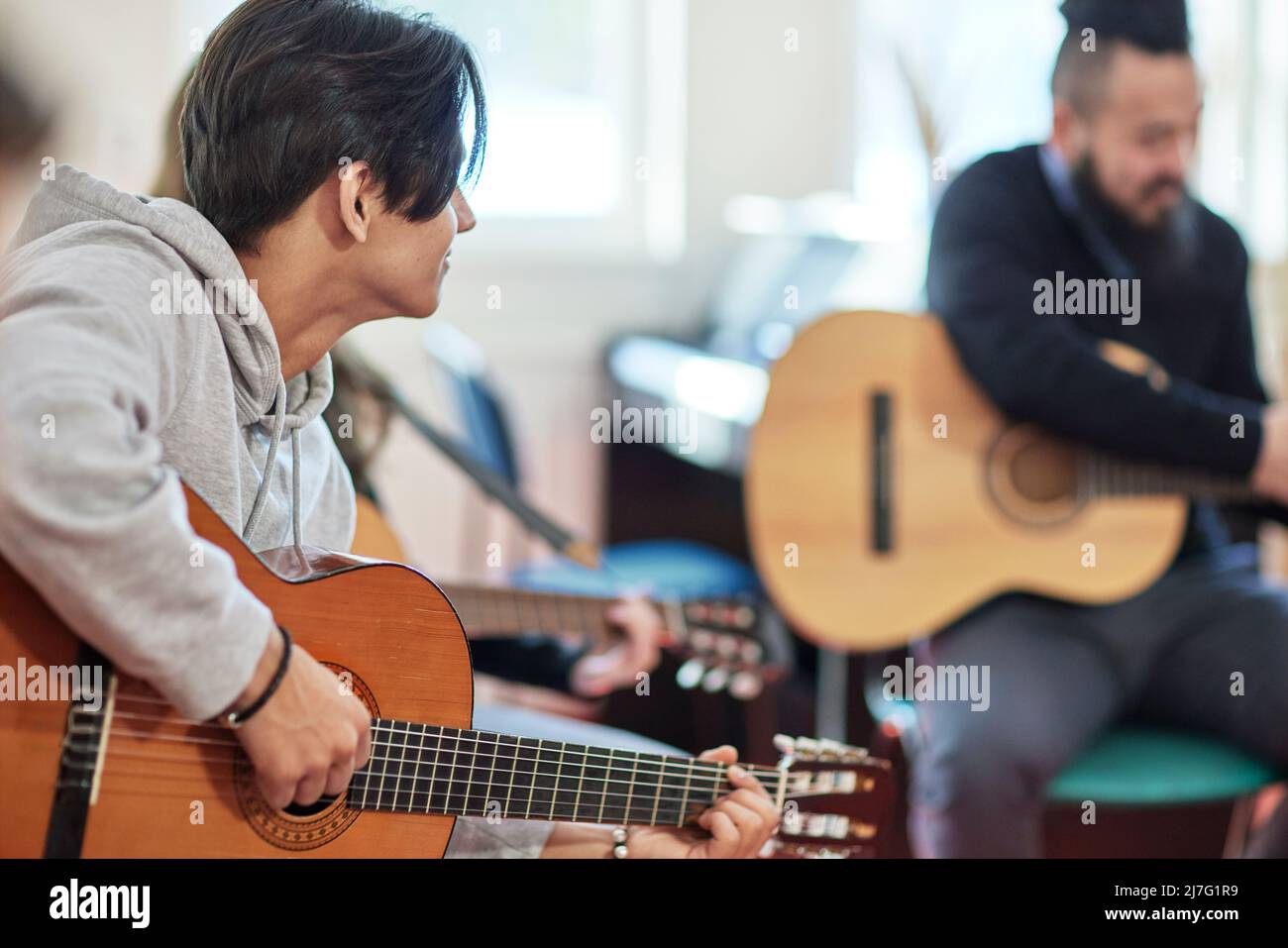 Teenage boy attending guitar lesson Stock Photo
