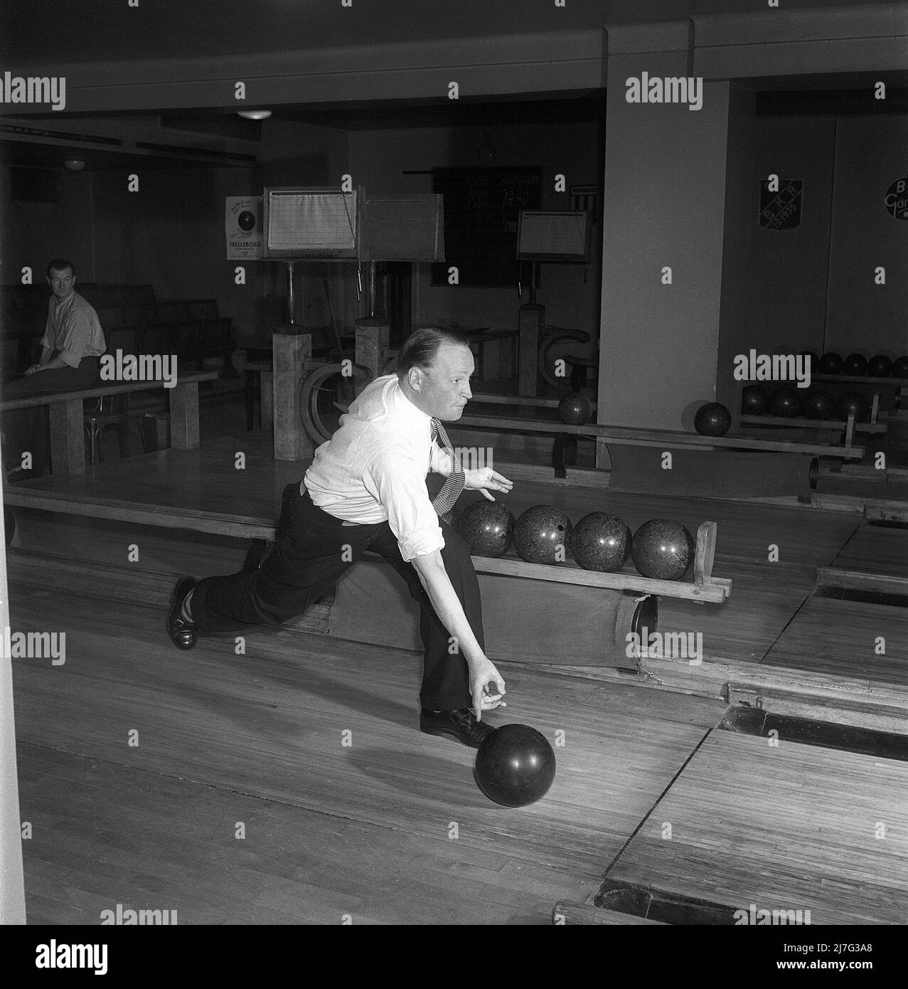 Bowling in the 1950s. A man in a bowling club throwing the ball. 1950
