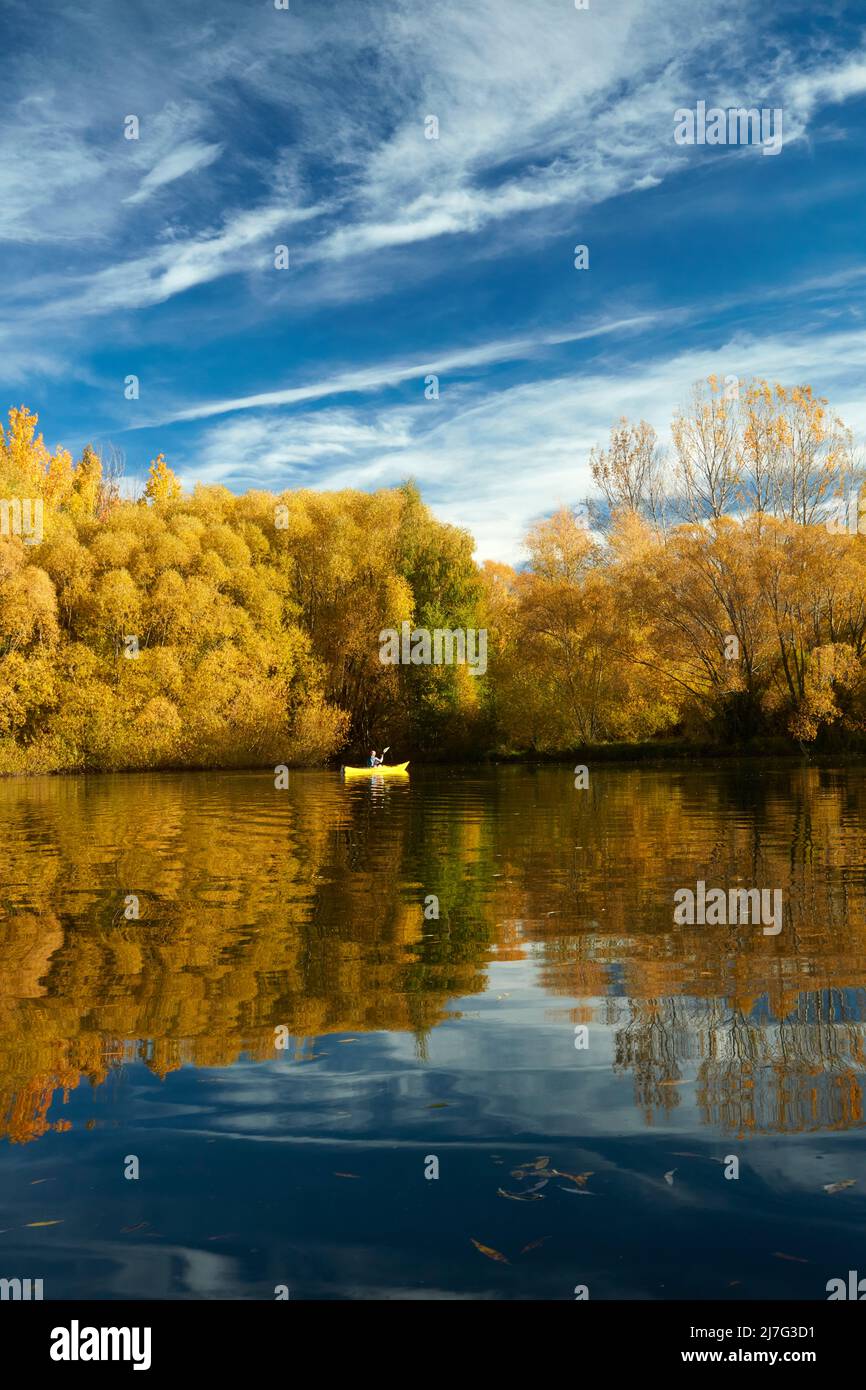 Kayak and autumn reflections in Wairepo Arm, near Twizel, Mackenzie District, North Otago, South Island, New Zealand (model released) Stock Photo