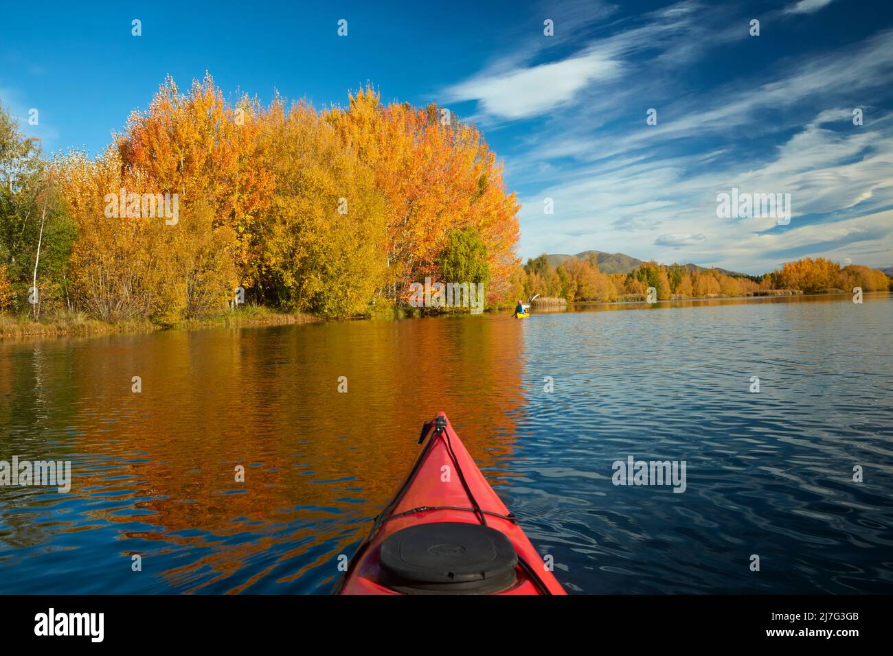 Kayak and autumn reflections in Kellands Pond, near Twizel, Mackenzie District, North Otago, South Island, New Zealand Stock Photo
