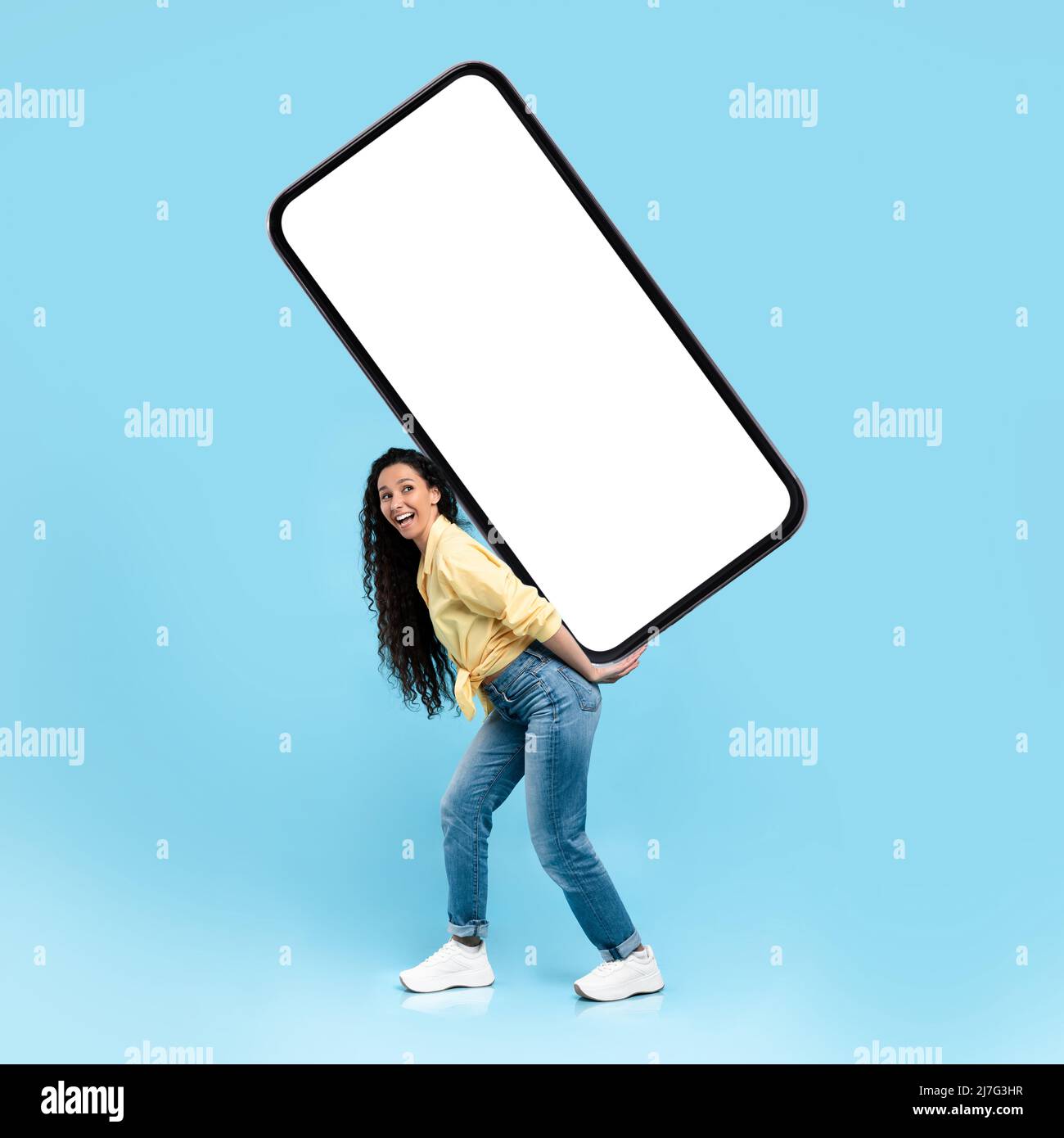 Excited lady holding heavy white empty smartphone screen Stock Photo