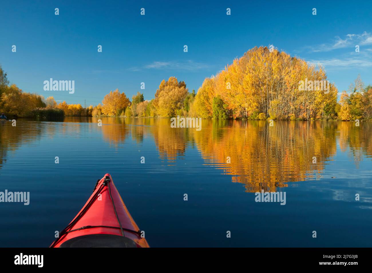 Kayak and autumn reflections in Kellands Pond, near Twizel, Mackenzie District, North Otago, South Island, New Zealand Stock Photo