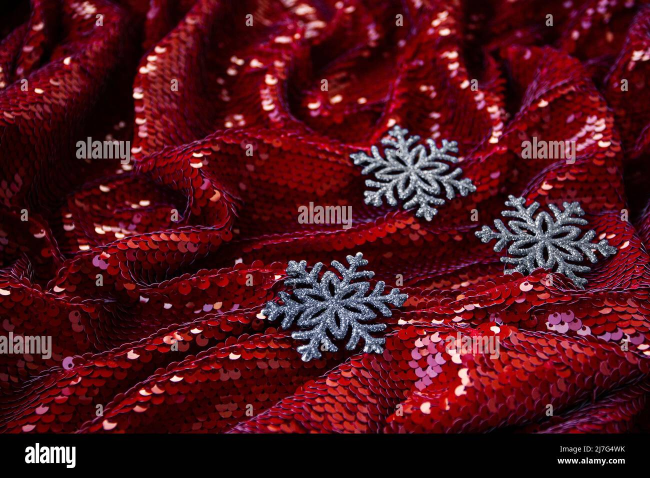 Red festive background with glitter and three silver decorations for Christmas tree for lettering and greeting card Stock Photo