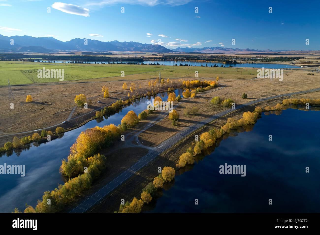 Kellands Pond (left), State Highway 8, and Wairepo Arm, Twizel, Mackenzie District, North Otago, South Island, New Zealand - drone aerial Stock Photo