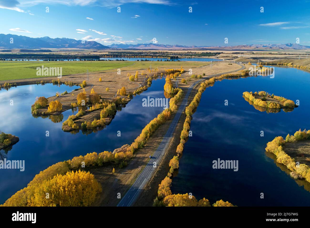 Kellands Pond (left), State Highway 8, and Wairepo Arm  (right), Twizel, Mackenzie District, North Otago, South Island, New Zealand - drone aerial Stock Photo