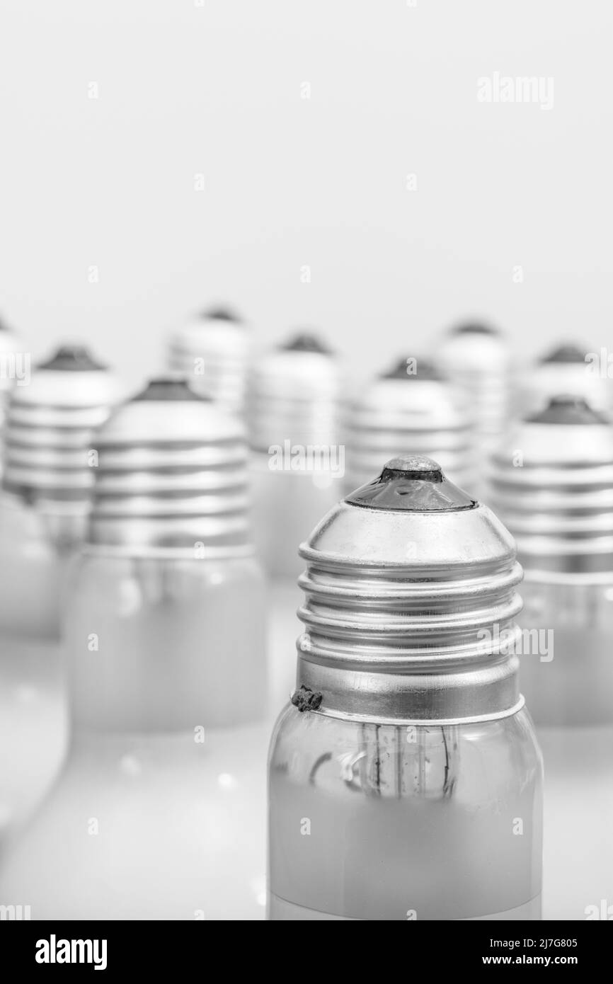 Monochrome close shot of glass incandescent light bulb cap with E27 / Edison Screw fitting. For illuminating, UK lighting industry, lighting abstract. Stock Photo
