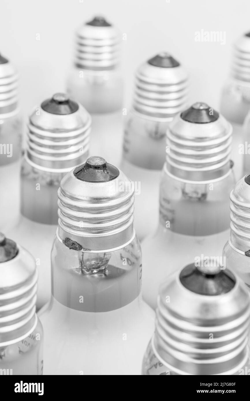 Monochrome close shot of glass incandescent light bulb cap with E27 / Edison Screw fitting. For illuminating, UK lighting industry, lighting abstract. Stock Photo