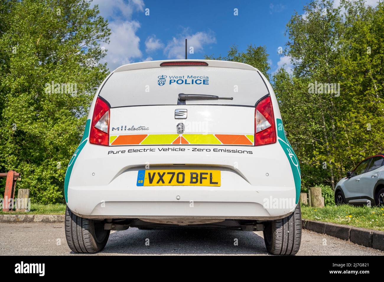 Close up rear view of new, electric, Zero Emission, Seat Mii police car of the West Mercia Police Force, parked outdoors in spring sunshine. Stock Photo