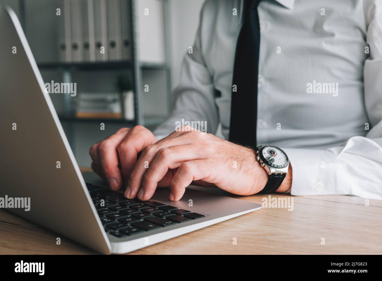 Professional accountant and tax adviser working on laptop computer in business office, selective focus Stock Photo