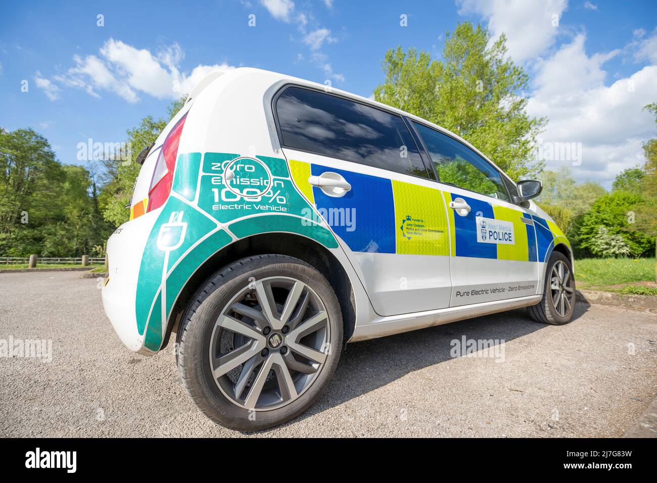 Close up of new electric Zero Emission Seat Mii police car (offside, rear) of West Mercia Force, isolated outdoors in public park in spring sunshine. Stock Photo