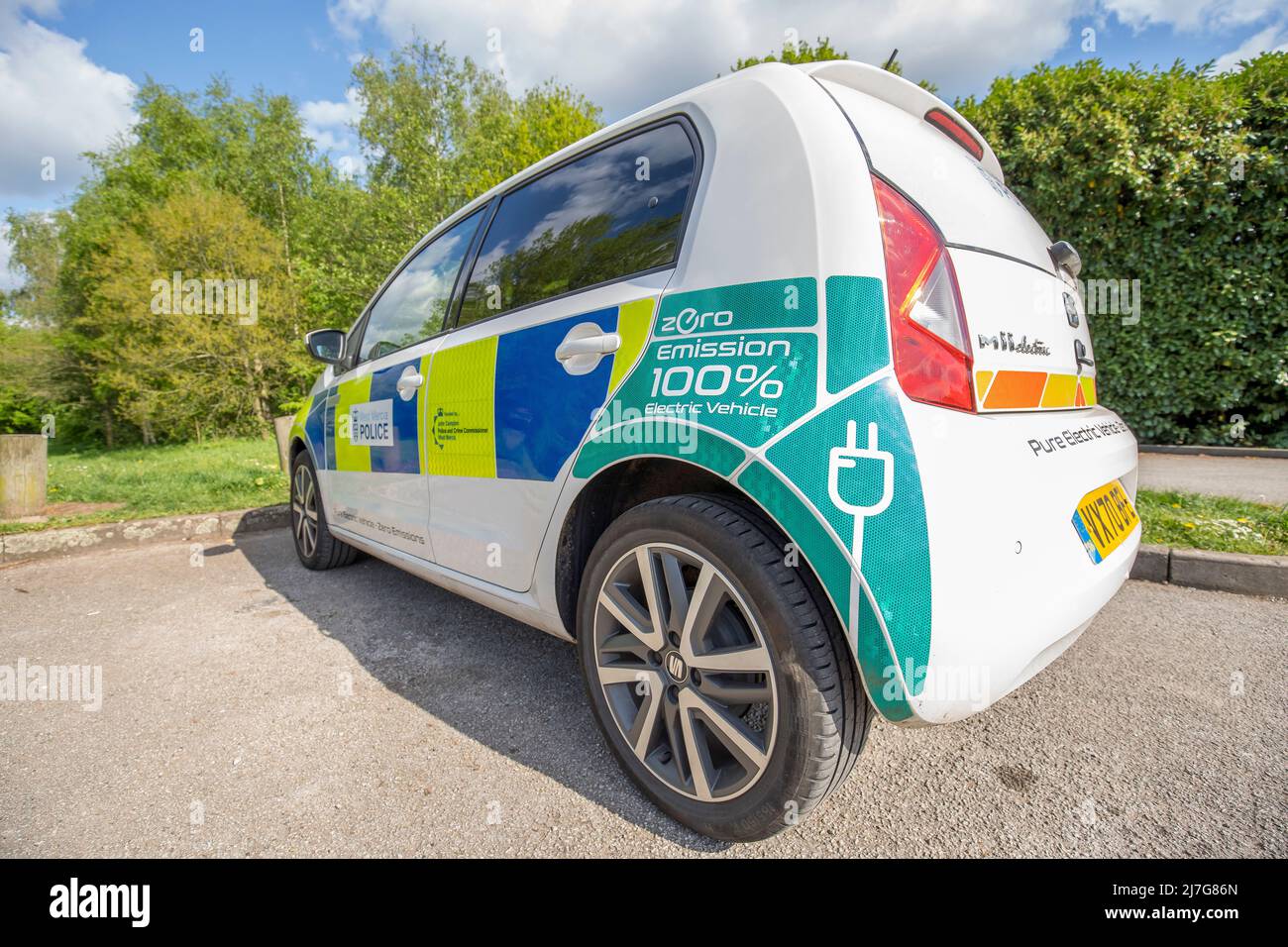 Close up of new electric Zero Emission Seat Mii police car (nearside rear) of West Mercia Force isolated outdoors in public park in UK spring sunshine. Stock Photo