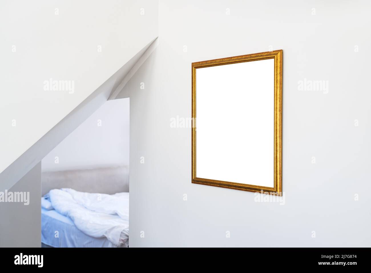 Mockup for painting in golden picture hanging on hotel room wall with copy space Stock Photo