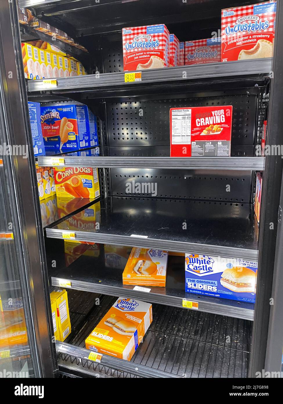 Grovetown, Ga USA - 04 20 22: Walmart freezer section empty holes and prices Stock Photo