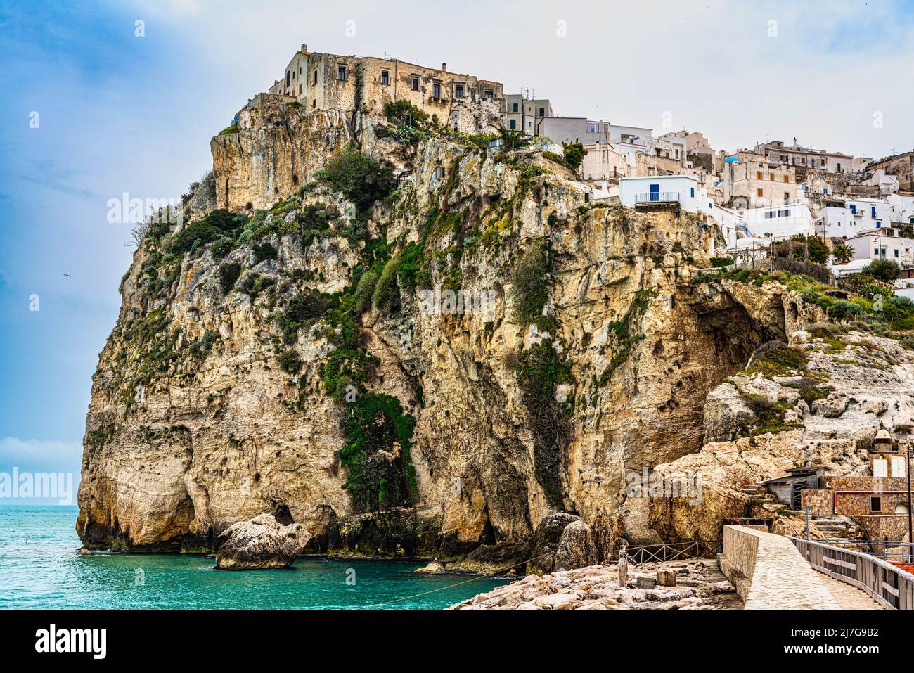 Landscape of the seaside town of Peschici perched on the precipitous cliffs on the Adriatic Sea. Peschici, Foggia province, Puglia, Italy, Europe Stock Photo