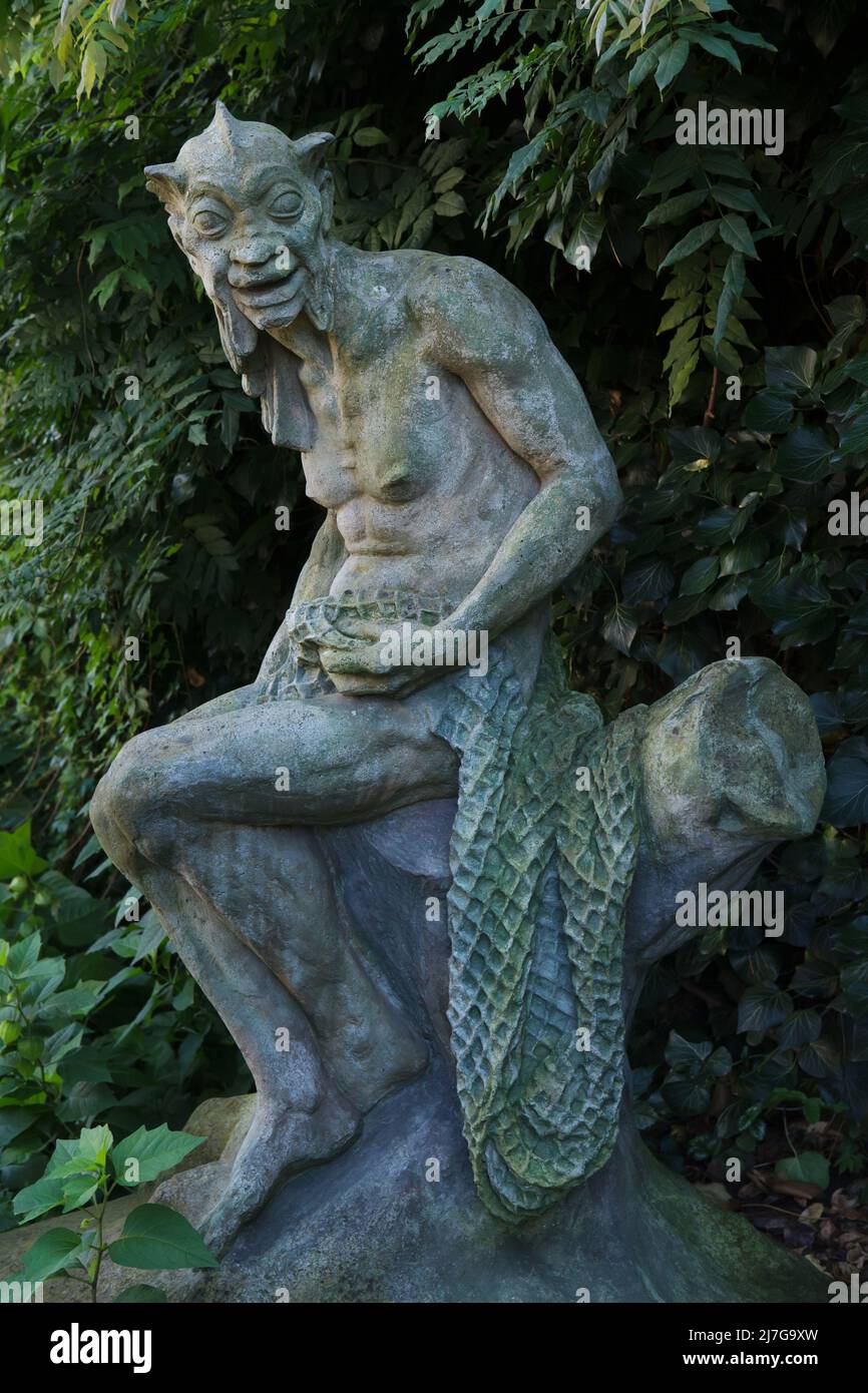 Abandoned statue of a vodník (Bohemian male water spirit) designed by Czech sculptor Karel Novák on display in the Art Garden (Umělecká zahrada) in Nusle district in Prague, Czech Republic. Former sculptural workshops used from 1924 to 1952 by Czech sculptor Karel Novák were transformed in the 1990s into romantic cultural space full of abandoned statues. Stock Photo