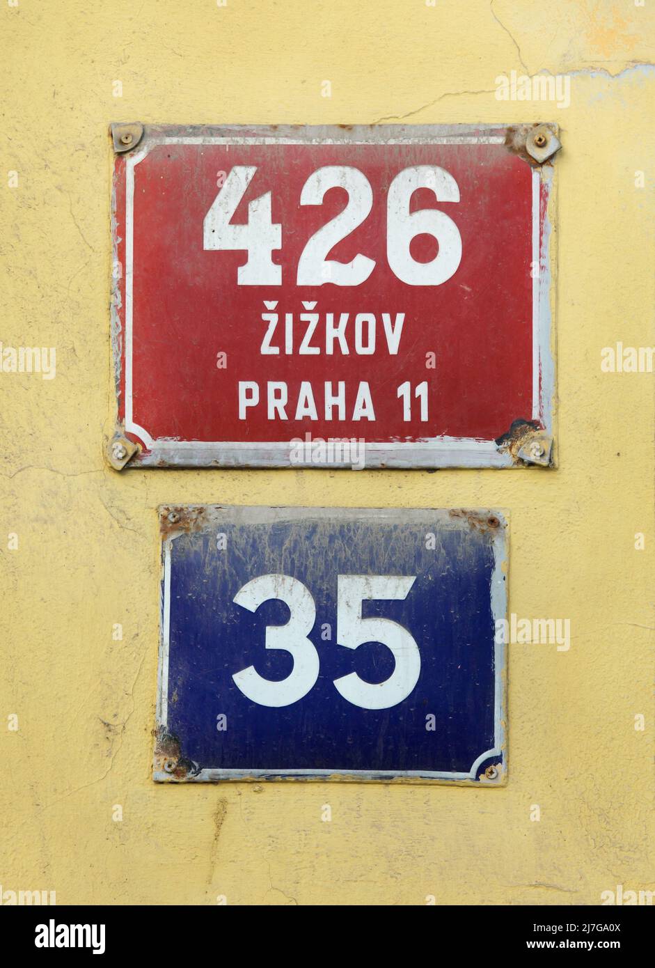 Two traditional red and blue house numbers in Žižkov district in Prague, Czech Republic. Red descriptive number is placed above the blue orientation number. Stock Photo