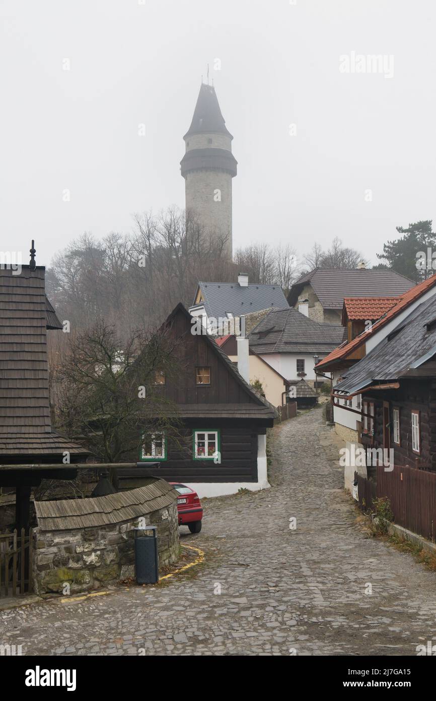 Štramberská Trúba (Štramberk Tower) raised over the traditional wooden houses (roubenka) in the picturesque town of Štramberk in the Moravian-Silesian Region of the Czech Republic. Stock Photo