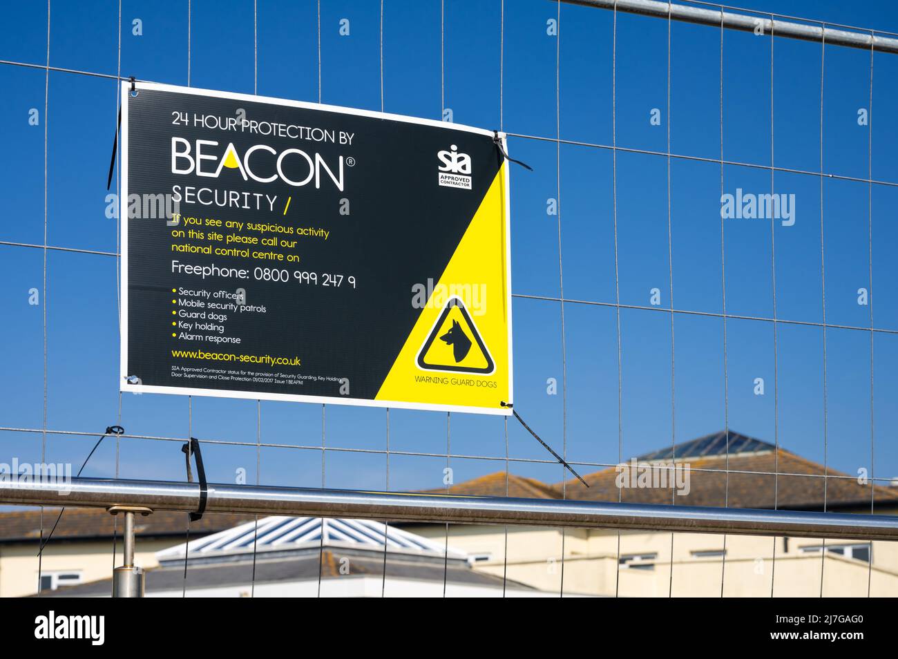 Beacon security sign on a fence for a site giving 24 hour protection in England, UK. Stock Photo