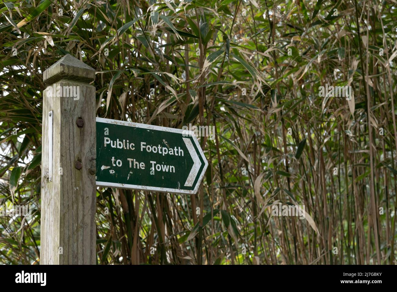 A sign pointing to a public footpath to the town. Stock Photo