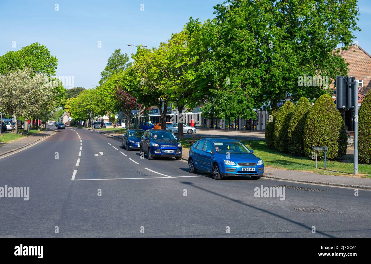 The main road and shops along The Street in the small British seaside town of Rustington Village, West Sussex, England, UK. Stock Photo
