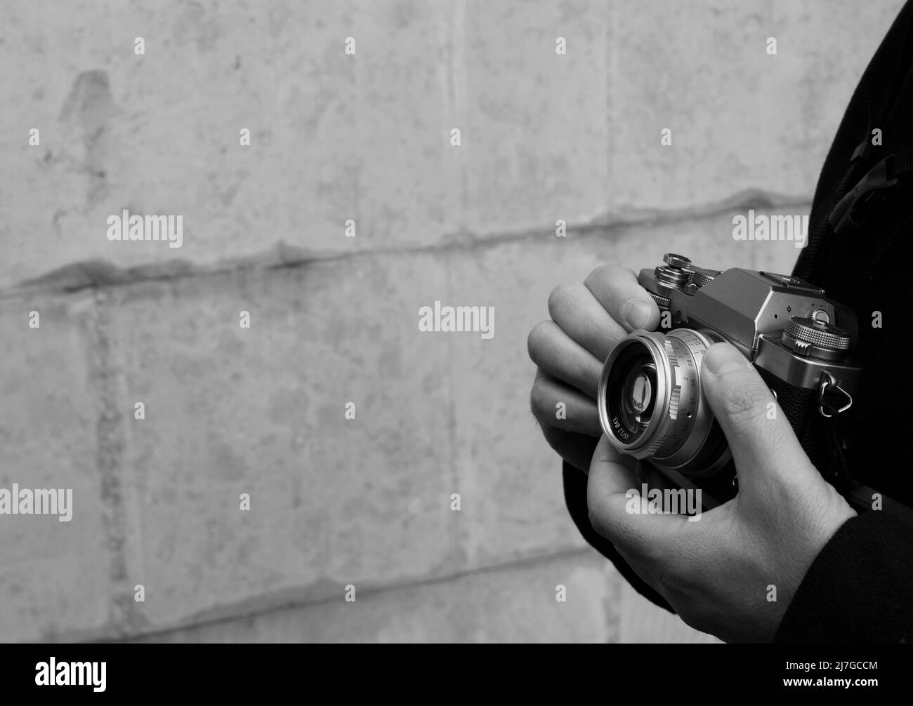 man using vintage camera ready to take photo - negative space and photography Stock Photo