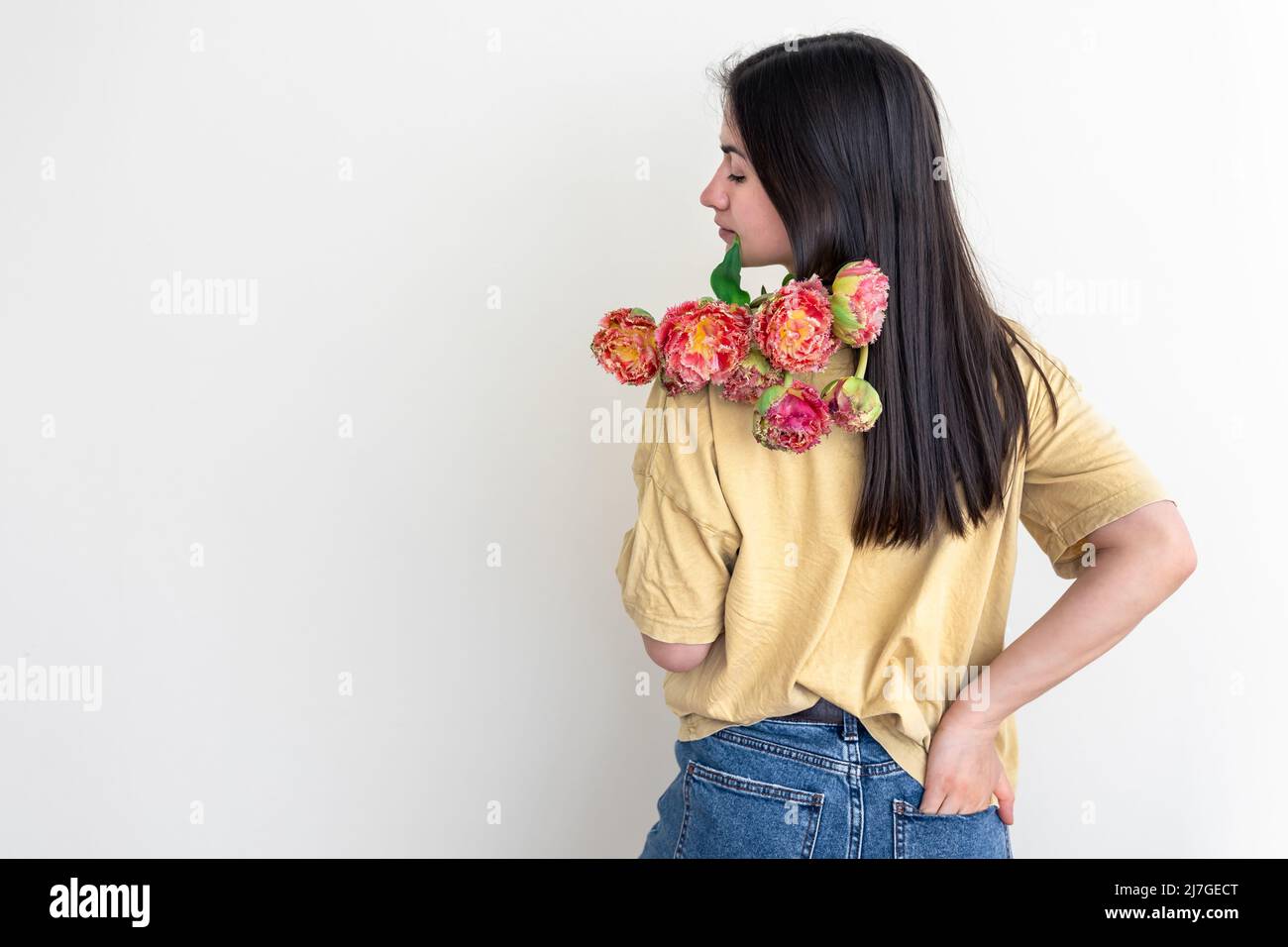 A young woman with a bouquet of flowers on a white background Stock ...