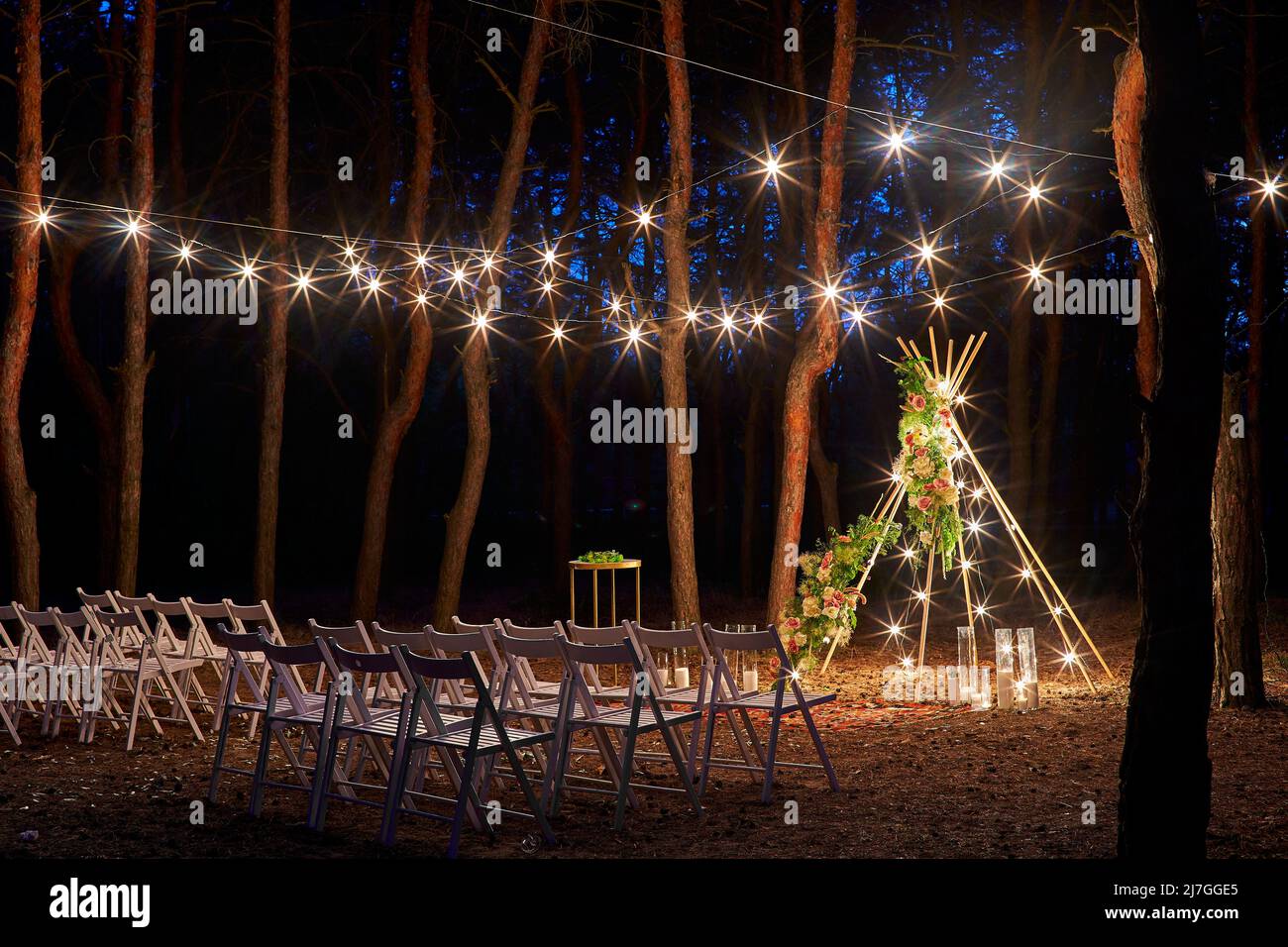 Festive string lights illumination on boho tipi arch decor on