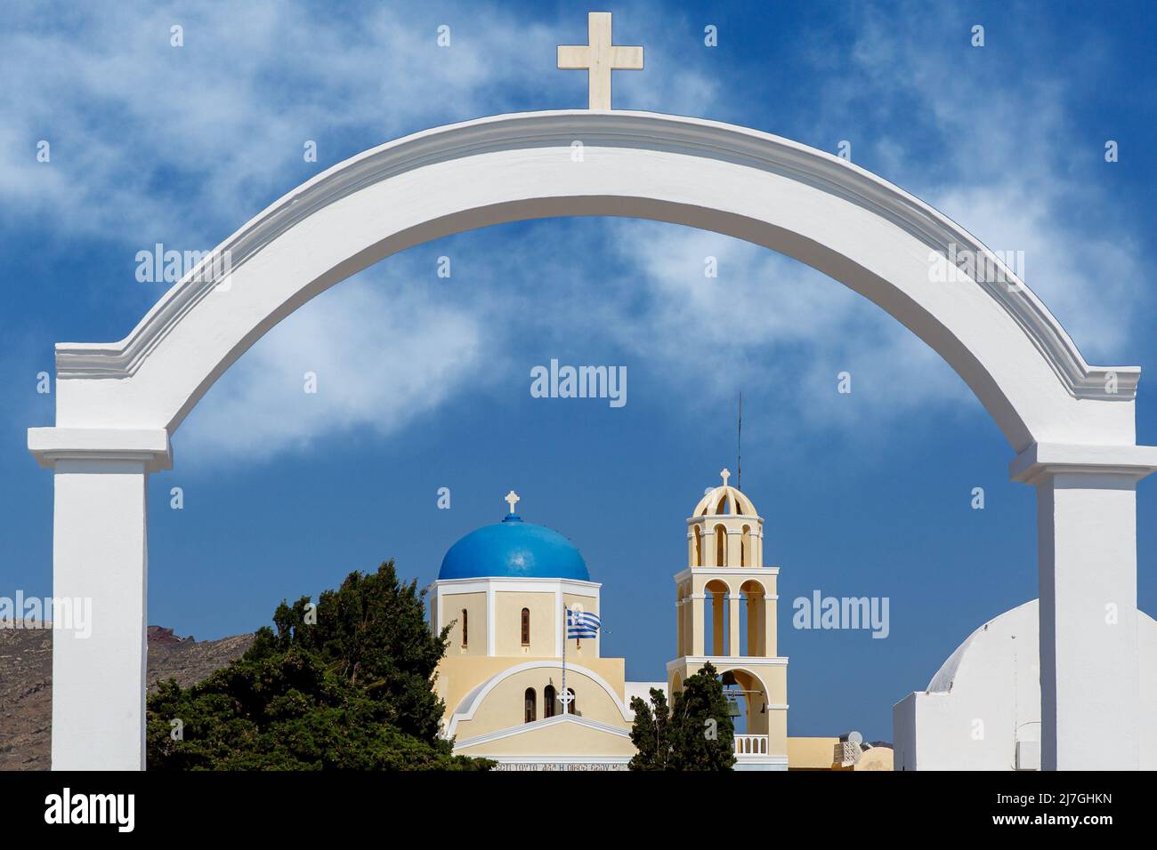 White arch with a cross under the blue sky. Greek church in the ...