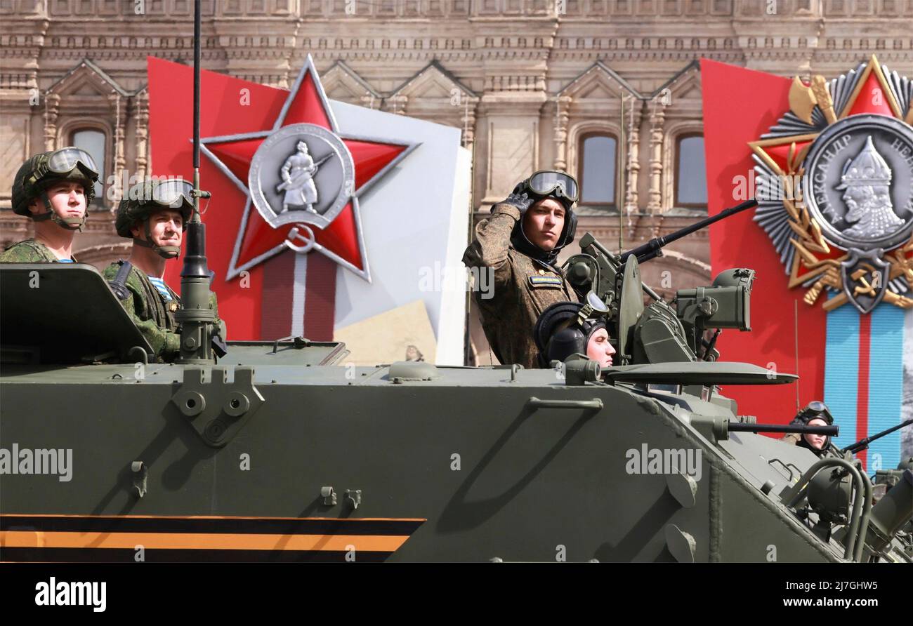 Moscow, Russia. 09th May, 2022. Russian soldiers salute from on top of a BTR-MDM Rakushka airborne armored personnel carrier as they roll past the review stand during the 77th annual Victory Day military parade celebrating the end of World War II at Red Square, May 9, 2022 in Moscow, Russia. Credit: Mikhail Metzel/Kremlin Pool/Alamy Live News Stock Photo