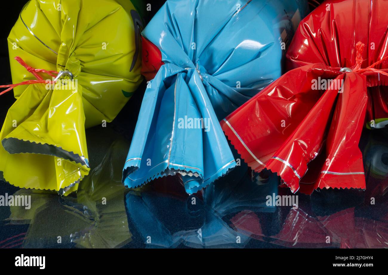 Candy in a bright wrapper on the table. Food on a black background Stock Photo