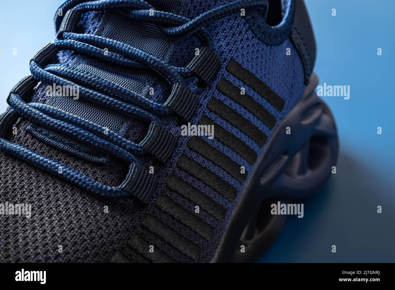 Curated visual reference: Lacing Of New Textile Mesh Sneakers On A Blue Background Photo Inspiration