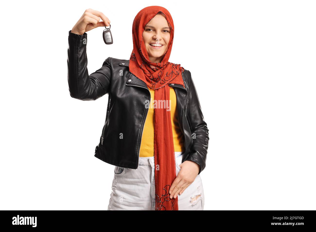 Young woman with a hijab holding car keys and smiling isolated on white background Stock Photo