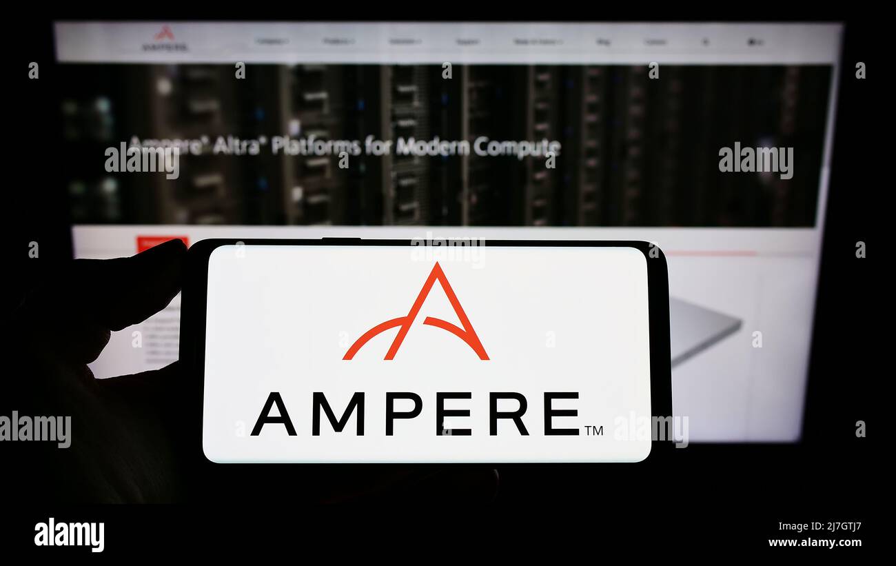 Person holding mobile phone with logo of US semiconductor company Ampere Computing LLC on screen in front of web page. Focus on phone display. Stock Photo