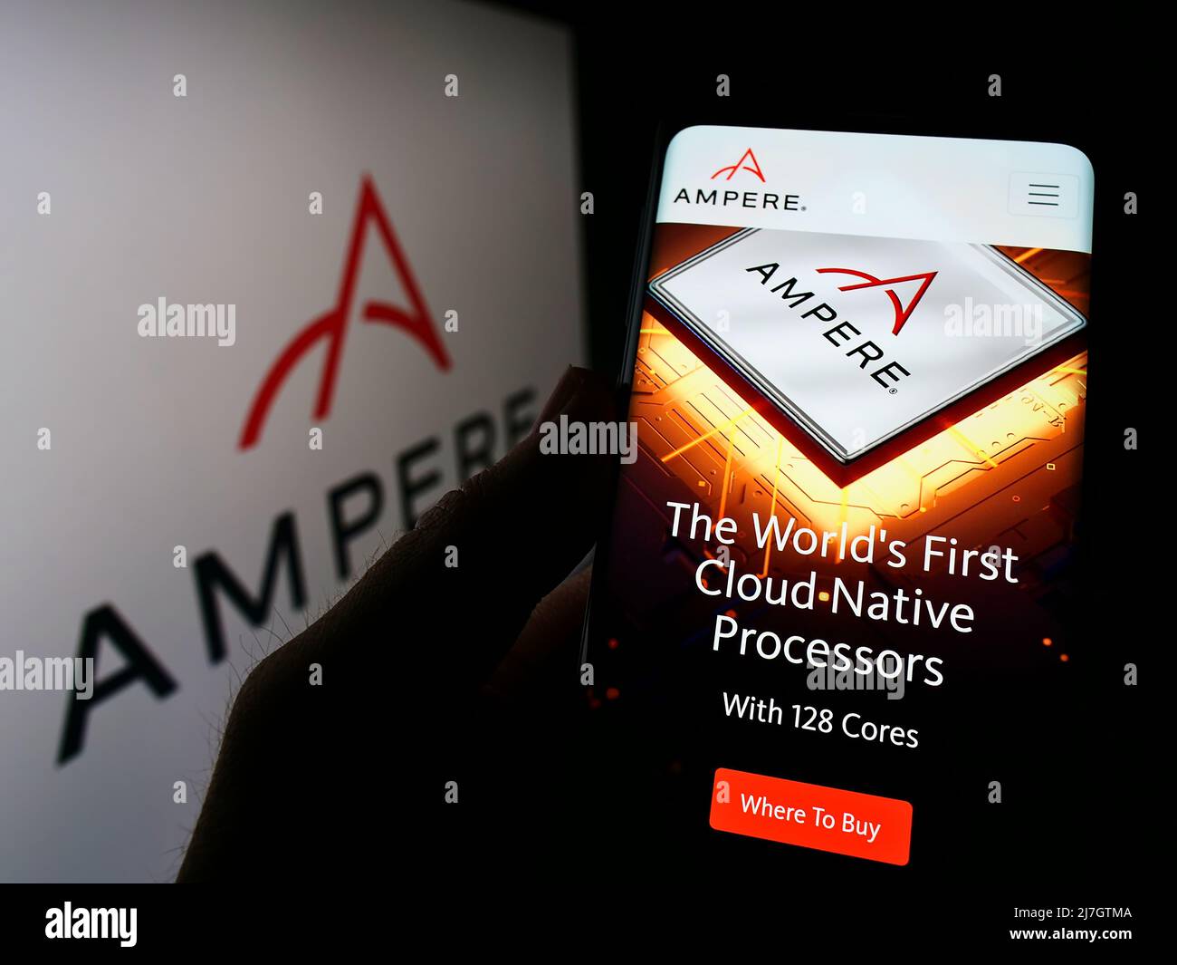 Person holding cellphone with website of US semiconductor company Ampere Computing LLC on screen with logo. Focus on center of phone display. Stock Photo