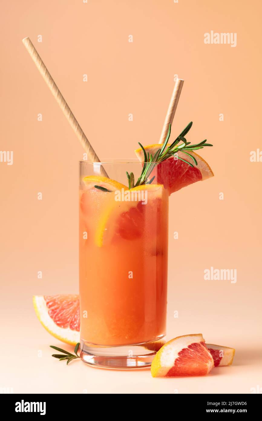 Summer cocktail with grapefruit, rosemary, and ice in a frozen glass ...