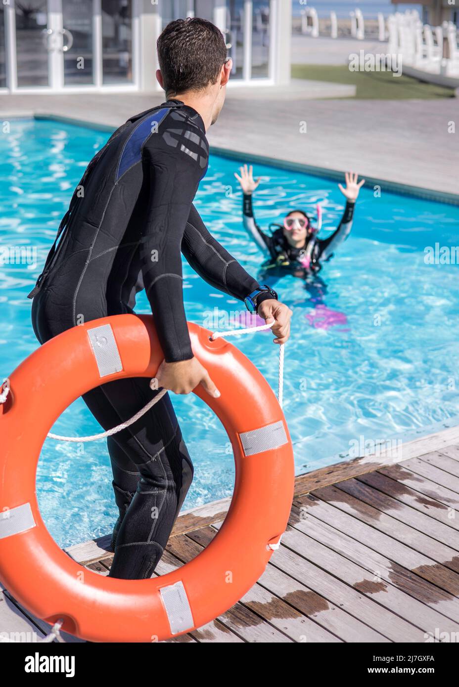 Scuba Diving rescue course skills distressed diver signal with lifeline being thrown to her Stock Photo