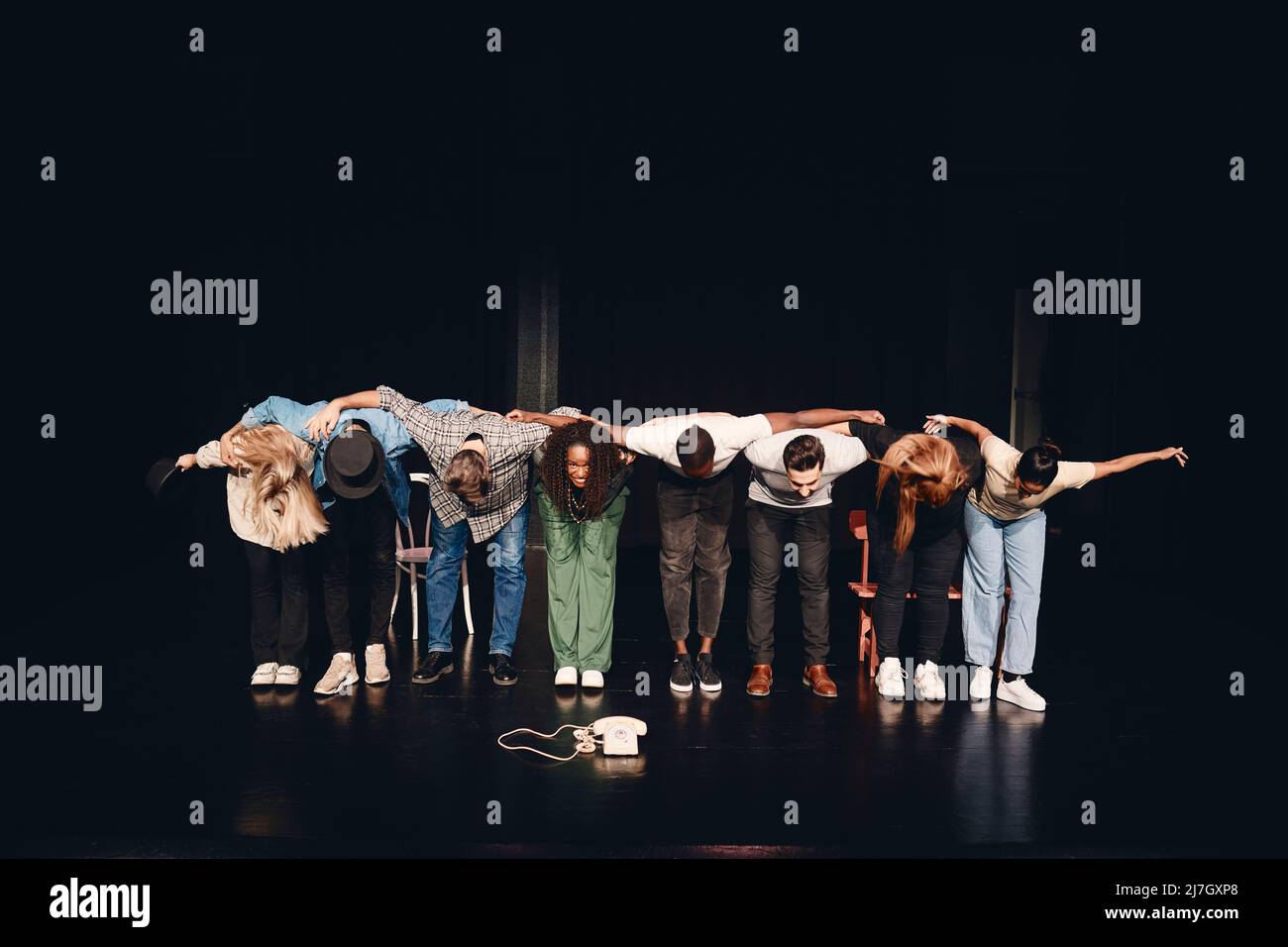Full length of multiracial male and female artists bowing together on stage Stock Photo