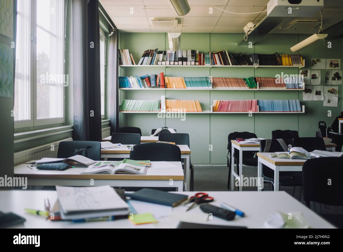 School supplies kept on desk in empty classroom Stock Photo