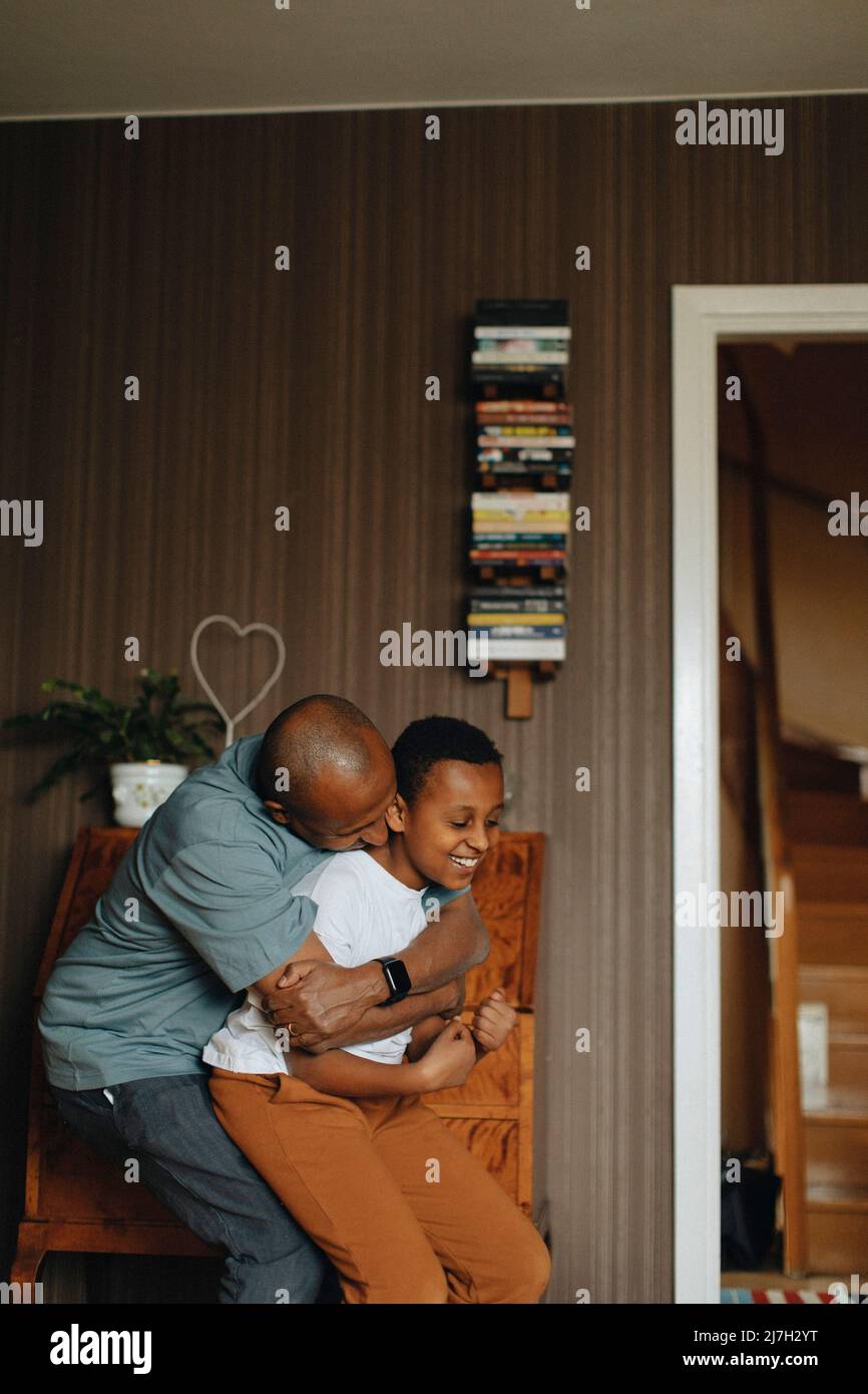 Father and son playing together at home Stock Photo