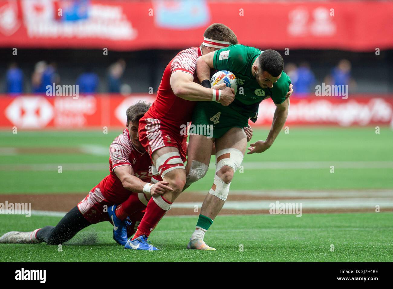 Vancouver, Canada, April 17, 2022: Andrew Smith (right, holding ball) of Team Ireland 7s tackled by two of Team Wales 7s players Morgan Sieniawski (middle) and Tom Brown (left) during Day 2 of the HSBC Canada Sevens at BC Place in Vancouver, Canada. Irealand won the match with the score 14-12. Stock Photo