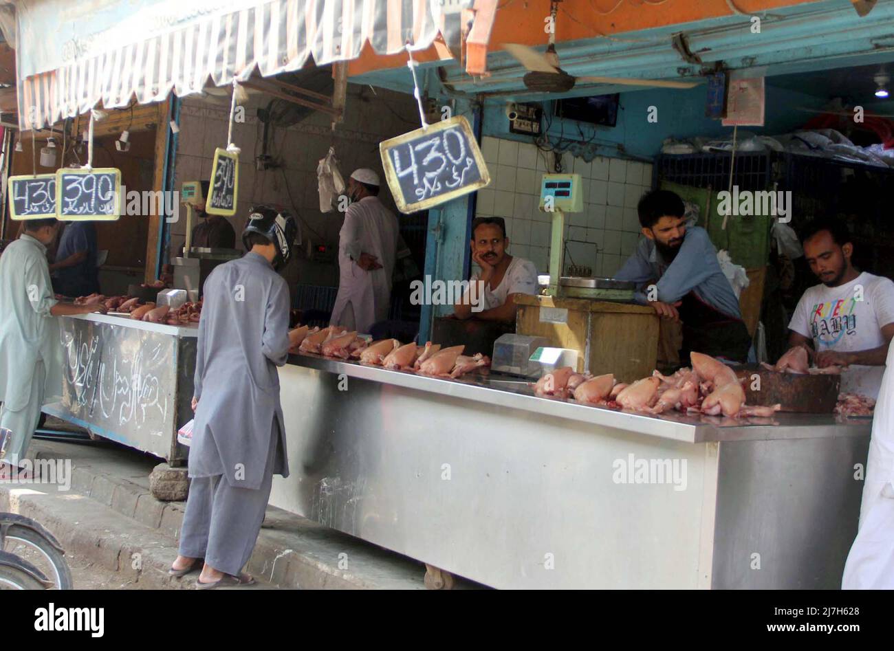 Shopkeepers sell chickenmeat at shop as the price hiking on chicken