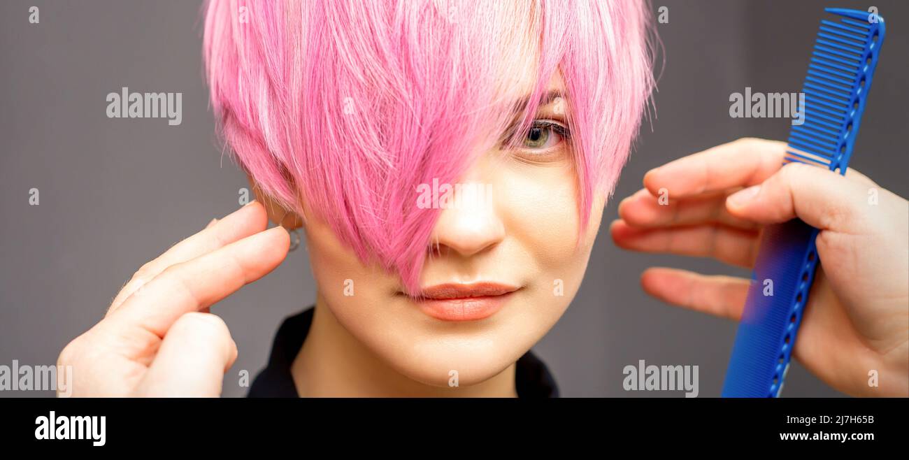 Hairdresser with hands and comb is checking out and fixing the short