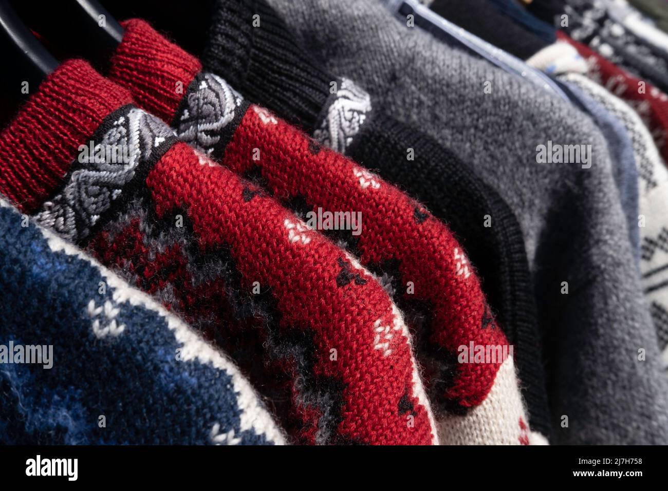Handmade woolen Scandinavian ladies cardigans, Norwegian style sweater in all kinds of colors and patterns, in an open air market stall Stock Photo