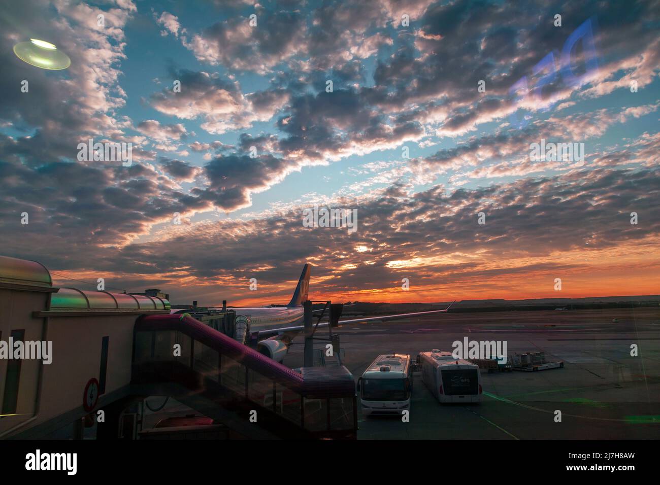Amazing sunrise with cloudscape in Madrid, at Barajas airport. Madrid is famous for its cloudscapes and this view from the waiting area confirms this. Stock Photo