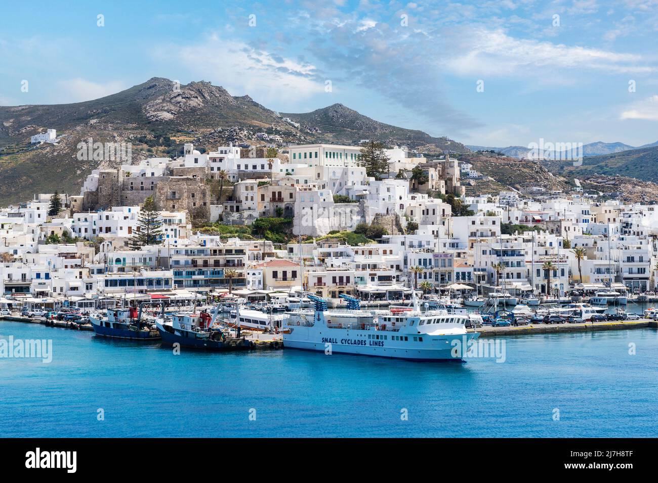 Port of Naxos island, in Cyclades, Greece, Europe. This is Chora, the capital town of Naxos, and the ship seen is the legendary .Skopelitis Stock Photo