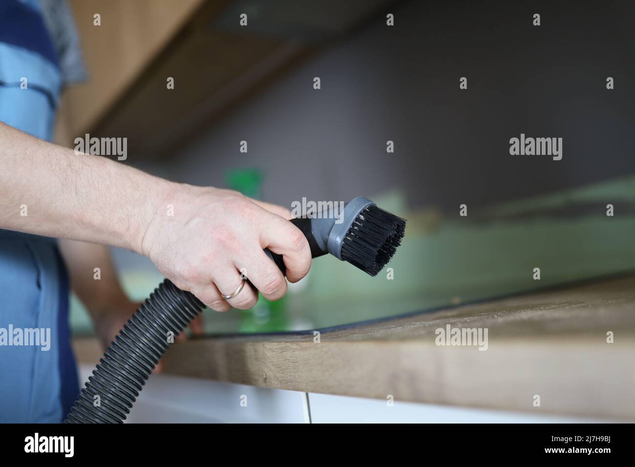 Male worker remove dust with vacuum cleaner, nozzle on cleaning device Stock Photo Alamy