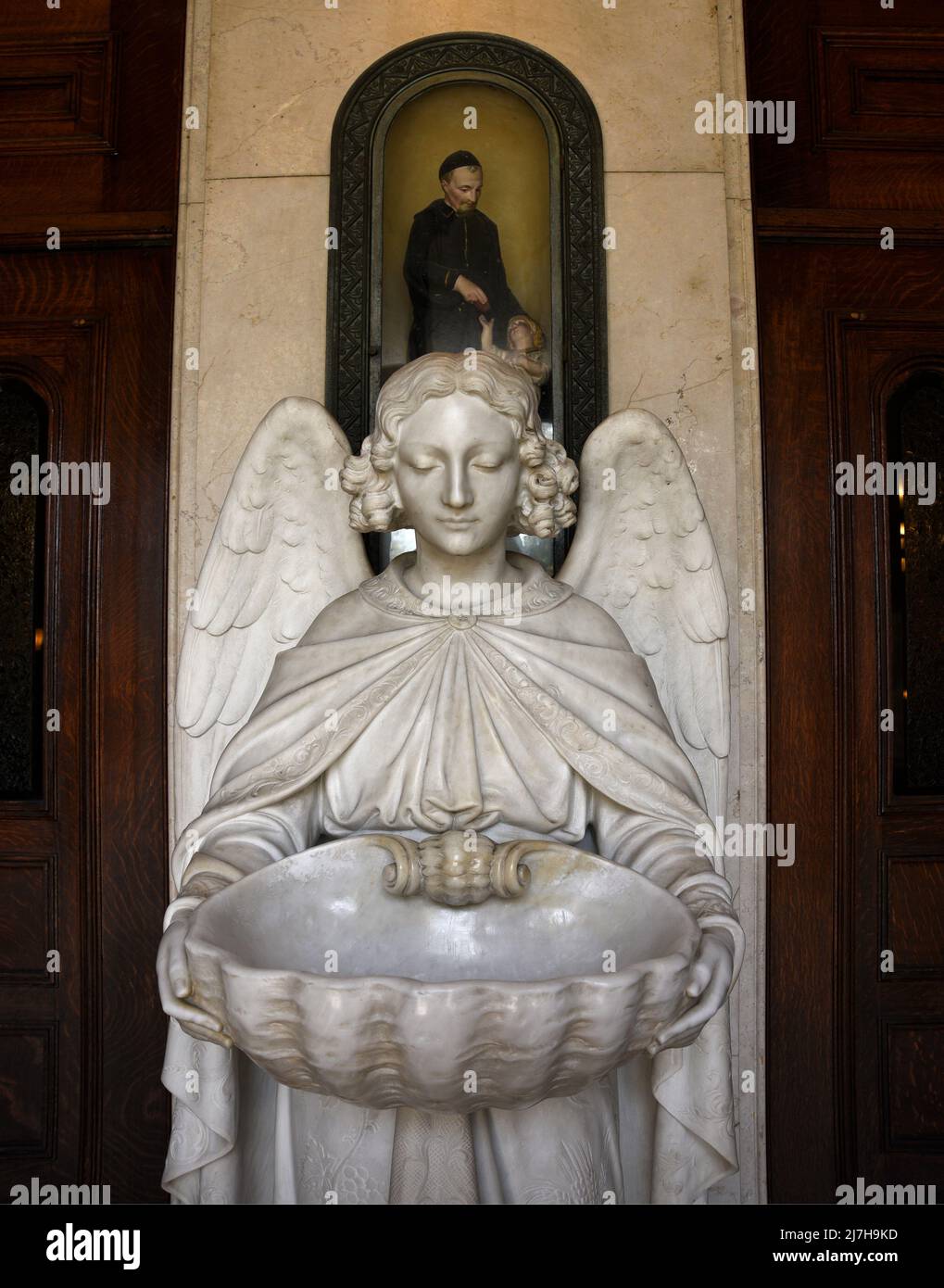 A marble holy water font in the form of an angel at the entrance to the landmark Saints Peter