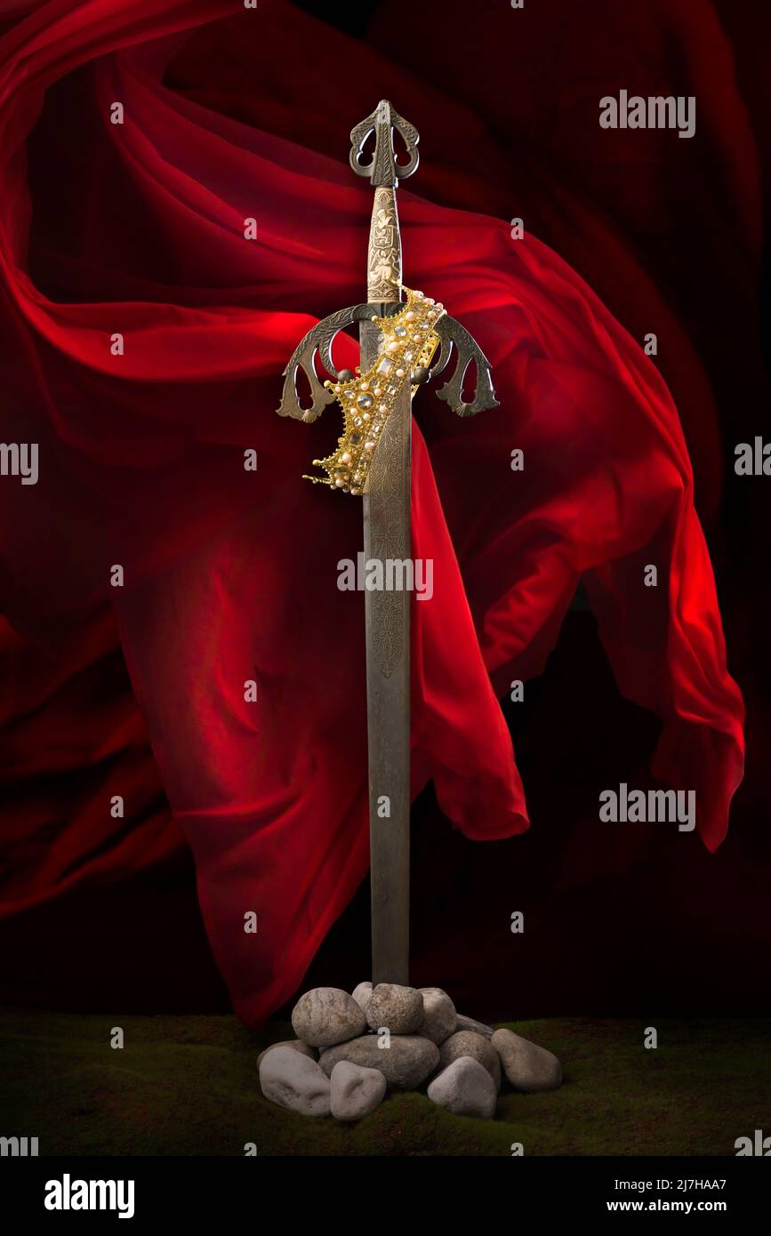 Antique medieval knight's sword standing against a romantic backdrop Stock Photo